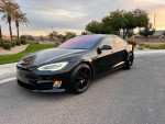 2018 Tesla Model S P100D in black with upgraded wheels parked outdoors