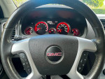Interior view of a well-maintained 2012 GMC Acadia SLE with clear dashboard and controls.