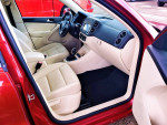 Interior view of a 2012 Volkswagen Tiguan with beige seats and modern dashboard design.
