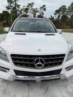 Front view of a 2015 Mercedes-Benz ML350 SUV with a stylish design and chrome accents.