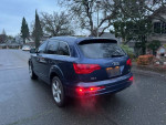 2008 Audi Q7 SUV in blue, parked on a street, showcasing its rear design.