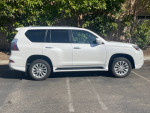 2021 Lexus GX 460 in Starfire Pearl White, side view, showcasing sleek design and premium features.