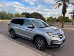 2020 Honda Pilot Touring FWD parked on street, showcasing sleek design and low mileage features