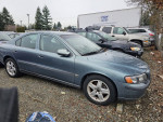 2002 Volvo S60 2.4 sedan parked at a repair shop lot with good exterior condition.