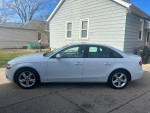 Side view of a 2013 Audi A4 parked outside, showcasing its clean design and alloy wheels.