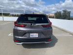 2021 Honda CR-V EX in showroom condition parked on a rooftop with clear skies.