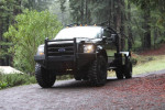 California legal 2000 Ford F550 4x4 truck with 41-inch tires parked on a forest road