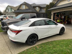 2022 Hyundai Elantra parked in a driveway, highlighting its sleek design and new winter tires.