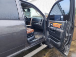 Interior view of a 2014 Ram 2500 Laramie 4WD, showing leather seats and dashboard features.