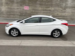 2014 Hyundai Elantra GLS in white, one owner, 89,000 miles, clean Carfax, parked on the street.