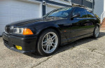 1995 BMW Dinan Supercharged M3 in excellent condition with distinctive styling parked outside.
