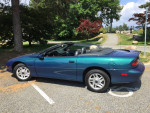 1995 Chevrolet Camaro Z28 convertible in mystic teal, showcasing sleek design and new tires.