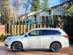 Side view of a 2018 Mitsubishi Outlander GT AWD, showcasing its sleek design and hybrid features.