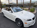 2012 white BMW M3 Convertible parked with palm trees in background, showcasing sleek design and luxury features.