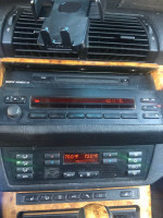 Interior controls of a 2005 BMW X5 4.8is AWD displaying temperature settings and audio system.