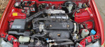 Engine compartment of a well-maintained 1993 Honda Civic DX with visible components and new battery.