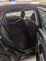 Interior view of a 2011 Toyota Matrix, showcasing spacious black fabric seating in the rear.