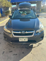 Front view of a 2012 Subaru Impreza 2.0i AWD hatchback with Yakima roof box and snow tires.