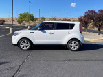 2014 Kia Soul with 147,000 miles parked in a clean lot, showcasing its white exterior and alloy wheels.