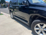 Side view of a 2010 Lexus GX 460 in excellent condition with minor scratches, showcasing its sleek design.