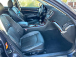 Interior view of a 2007 Infiniti G35 sedan, featuring black leather seats and modern dashboard design.