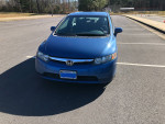 2006 Honda Civic four-door sedan in blue, 105,000 miles, featuring automatic transmission and gray cloth interior.