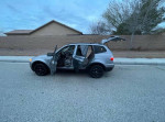2009 BMW X3 SUV with open doors parked on the street, showcasing its spacious interior and family-friendly features.