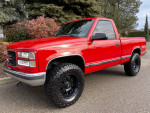 1997 GMC Sierra 1500 SL 4WD with 66K miles, red exterior, black wheels, parked outdoors.