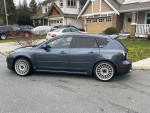 2009 MAZDASPEED 3 in excellent condition, showcasing modifications, parked on a residential street.