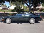 1997 Nissan Maxima sedan with 50,000 miles, featuring new brakes and tires, parked on a street under trees.