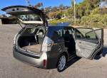 2012 Toyota Prius V5 hybrid car with open trunk and spacious interior, ideal for families or rideshare drivers.