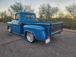 1959 Chevy truck with a blue exterior, rear view showcasing 20 inch wheels and disc brakes, located in Tucson.
