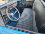 Interior view of a 1959 Chevy truck with a modern steering wheel and updated seating upholstery.