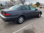 2000 Toyota Camry with 157k miles parked, featuring a clean title and recent maintenance.