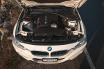 Overview of the engine bay of a 2013 BMW 328i with features like M-Sport wheels and Alpine sound system.