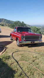 1975 Chevrolet C10 Stepside truck with custom modifications in a scenic outdoor setting.