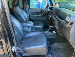 Interior of 2017 Jeep Wrangler Unlimited with black leather seats and modern dashboard features