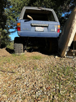 2007 blue Toyota 4Runner with off-road modifications parked on gravel ground