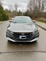 Front view of a 2020 Honda Accord Sport FWD sedan in Modern Steel Metallic, parked on a rainy street.