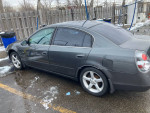 2006 Nissan Altima 3.5 SE FWD parked outside, showing minor cosmetic damage and check engine light on.