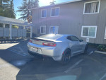 2018 Chevrolet Camaro 1SS RWD parked near mailboxes, showcasing its sleek design and performance features.