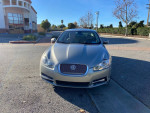 Front view of a 2010 Jaguar XF with clean body and 71k miles, parked in a sunny location.
