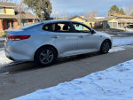 2016 Kia Optima parked on snowy street, clean and well-maintained with 64,000 miles and turbo charge.