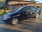 2014 Honda Civic LX sedan in black with low mileage, parked outside, showcasing sleek design.
