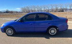 2003 Honda Civic in good condition with blue paint and aftermarket aluminum wheels parked outdoors