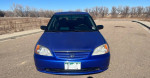 Front view of a blue 2003 Honda Civic parked, showcasing its good condition and updated maintenance.