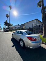 2008 Chrysler Sebring parked on a sunny street, showcasing its sleek silver exterior and surroundings
