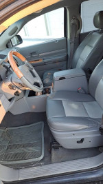 Interior view of a Chrysler Aspen SUV with comfortable seating and a modern dashboard setup.
