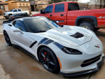 2014 Chevrolet Corvette with Borla exhaust system parked in driveway, showcasing sleek design and low mileage.