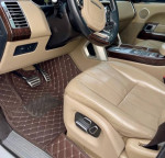 Interior view of 2014 Land Rover Range Rover with premium tan leather seats and wooden accents